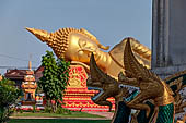 Vientiane, Laos - Pha That Luang, large gilded reclining Buddha within the temple area. 